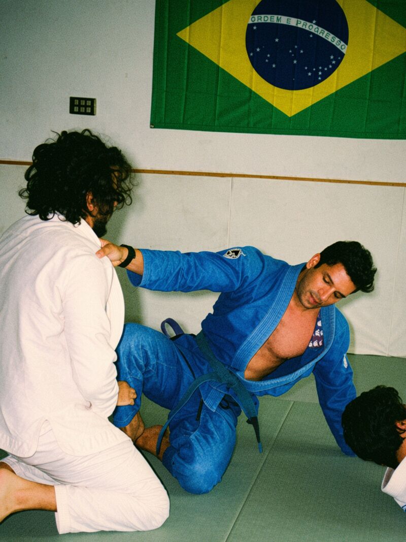 Two adults drilling a guard pass in the gi at Mikado Jiu Jitsu