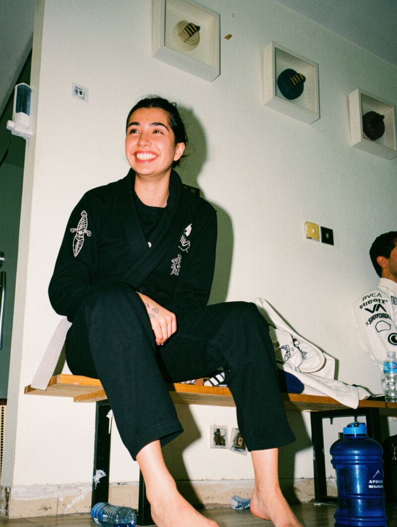 A student laughing on the bench between rounds