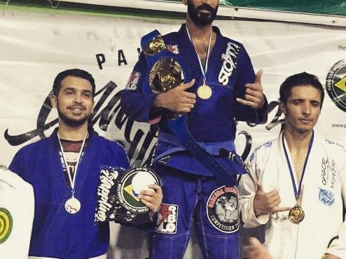 Shaheryar Khalid, left, with his silver medal on the podium at Pakistan Grappling Challenge 3