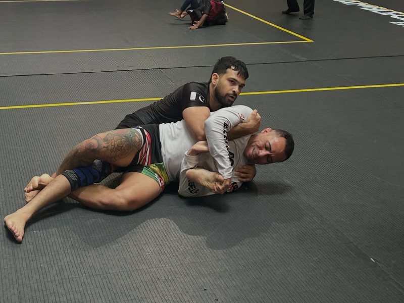 Shaheryar Khalid in a black rash guard taking his opponent’s back during his black belt debut at Grappling Industries Kuala Lumpur